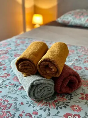 a pile of towels sitting on top of a bed at Athens Harmony in Athens