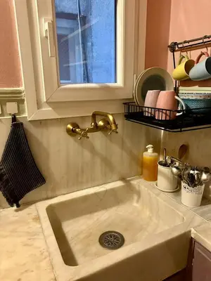 a sink in a kitchen with a window above it at Athens Harmony in Athens