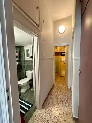 a hallway with a bathroom with a toilet at Athens Harmony in Athens