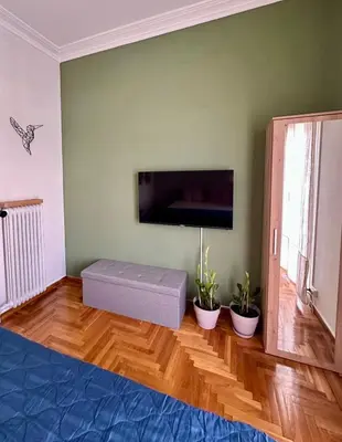 a living room with a large flat screen tv at Athens Harmony in Athens