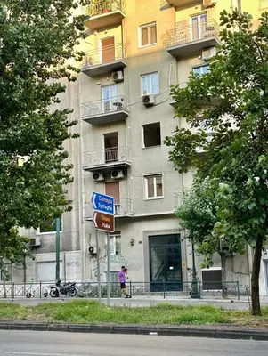 a person walking in front of a building at Athens Harmony in Athens