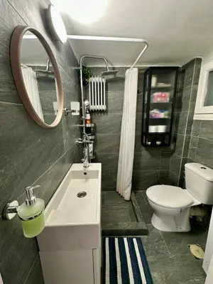 a bathroom with a sink and a toilet and a mirror at Athens Harmony in Athens