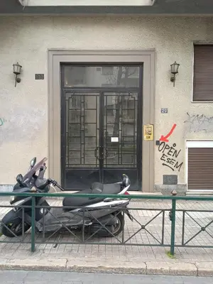 a surfboard on a table in front of a building at Athens Harmony in Athens
