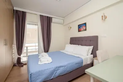 a bedroom with a bed with towels on it at FilOikos Veranda Deck Escape and Retreat 3Br 2Ba in Athens