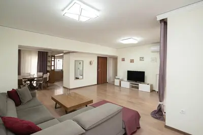 a living room with a couch and a table at FilOikos Veranda Deck Escape and Retreat 3Br 2Ba in Athens
