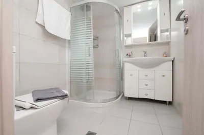 a bathroom with a shower and a toilet and a sink at FilOikos Veranda Deck Escape and Retreat 3Br 2Ba in Athens