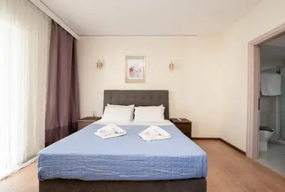 a bedroom with a bed with two towels on it at FilOikos Veranda Deck Escape and Retreat 3Br 2Ba in Athens