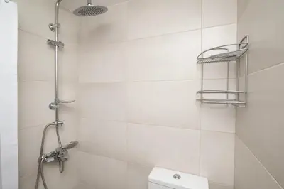 a white bathroom with a shower and a toilet at FilOikos Veranda Deck Escape and Retreat 3Br 2Ba in Athens