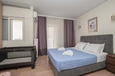 a bedroom with a bed with two towels on it at FilOikos Veranda Deck Escape and Retreat 3Br 2Ba in Athens