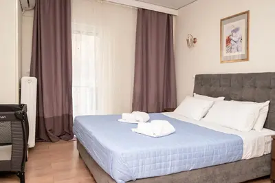 a bedroom with a bed with two towels on it at FilOikos Veranda Deck Escape and Retreat 3Br 2Ba in Athens