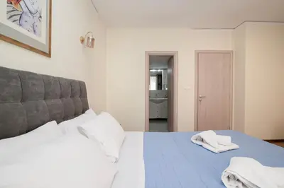 a bedroom with a bed with towels on it at FilOikos Veranda Deck Escape and Retreat 3Br 2Ba in Athens