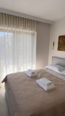 a bedroom with a large bed with two towels on it at CasaMare Lagonisi Athens Riviera Luxury modern villas apartment's in Lagonissi