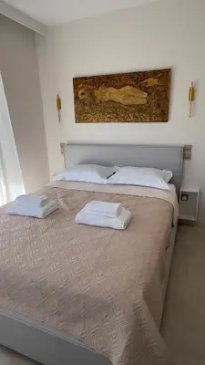 a bedroom with two beds with white towels on them at CasaMare Lagonisi Athens Riviera Luxury modern villas apartment's in Lagonissi
