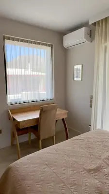 a bedroom with a bed and a desk and a window at CasaMare Lagonisi Athens Riviera Luxury modern villas apartment's in Lagonissi