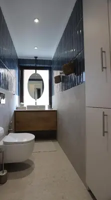 a bathroom with a tub and a sink and a mirror at Modern Coastal Voula Flat in Athens