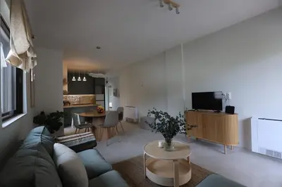 a living room with a couch and a table at Modern Coastal Voula Flat in Athens