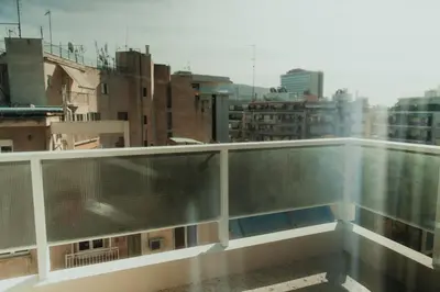 a balcony with a view of a city at The HostMaster CityZen Suite in Athens