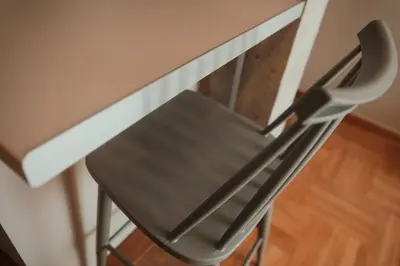 a metal chair sitting next to a counter at The HostMaster CityZen Suite in Athens