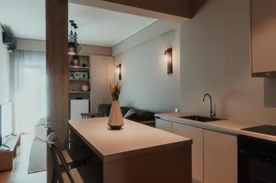 a kitchen with a counter with a vase on it at The HostMaster CityZen Suite in Athens