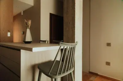 a chair sitting at a counter in a kitchen at The HostMaster CityZen Suite in Athens