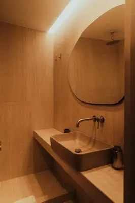 a bathroom with a sink and a mirror at The HostMaster CityZen Suite in Athens