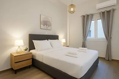 a bedroom with a large white bed and a window at The Urban Sanctuary in the heart of Sepolia, Athens in Athens