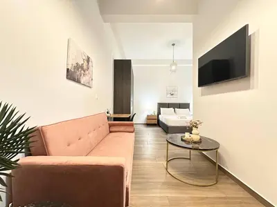 a living room with a couch and a table at The Urban Sanctuary in the heart of Sepolia, Athens in Athens