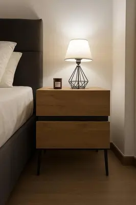 a nightstand with a lamp on it next to a bed at The Urban Sanctuary in the heart of Sepolia, Athens in Athens