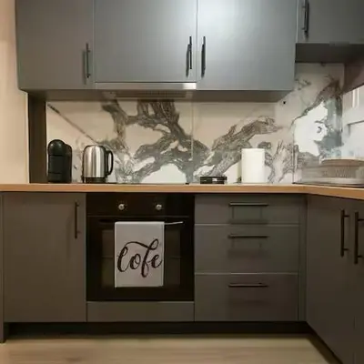 a kitchen with an oven with a sign on it at The Urban Sanctuary in the heart of Sepolia, Athens in Athens