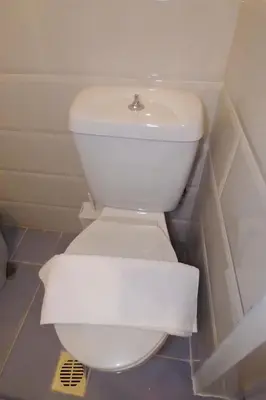 a toilet with a roll of toilet paper on it at Panormou Studio metro station by MPS in Athens