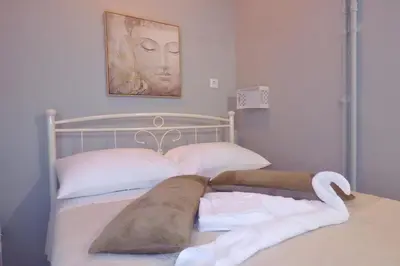 a bedroom with a bed with towels on it at Panormou Studio metro station by MPS in Athens