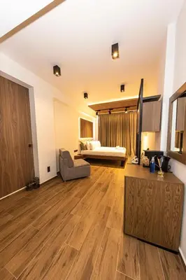 a large living room with a couch and a television at Acropolis View 302 By Pantheon Ermou in Athens