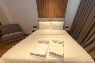 a bedroom with a bed with two towels on it at Acropolis View 302 By Pantheon Ermou in Athens