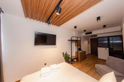 a bedroom with a bed and a couch at Acropolis View 302 By Pantheon Ermou in Athens