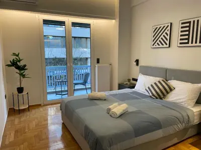a bedroom with a bed with two towels on it at Astidamantos, fantastic apartment in Pangrati in Athens
