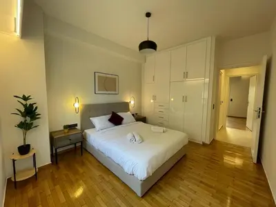 a bedroom with a bed with two towels on it at Astidamantos, fantastic apartment in Pangrati in Athens
