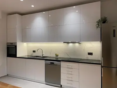 a kitchen with white cabinets and a stainless steel refrigerator at Astidamantos, fantastic apartment in Pangrati in Athens
