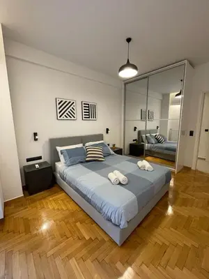 a bedroom with a large bed and a large mirror at Astidamantos, fantastic apartment in Pangrati in Athens