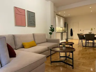 a living room with a couch and a table at Astidamantos, fantastic apartment in Pangrati in Athens