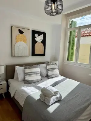 a bedroom with a large bed with towels on it at Plaka Two-Bedroom Flat with Acropolis View Terrace in Athens