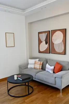 a living room with a couch and a table at Plaka Two-Bedroom Flat with Acropolis View Terrace in Athens