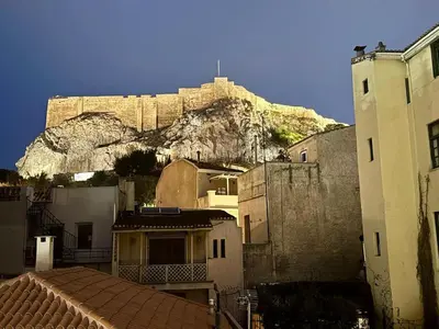 a mountain in the background with houses and buildings at Plaka Two-Bedroom Flat with Acropolis View Terrace in Athens