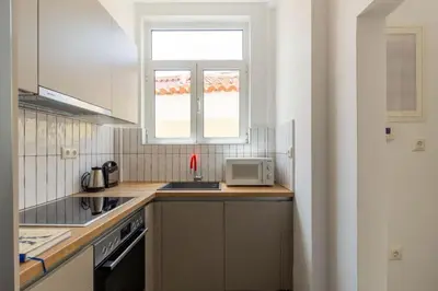a kitchen with a sink and a microwave at Plaka Two-Bedroom Flat with Acropolis View Terrace in Athens