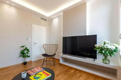a living room with a large flat screen tv at Plaka Two-Bedroom Flat with Acropolis View Terrace in Athens