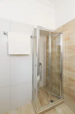 a shower with a glass door in a bathroom at Plaka Two-Bedroom Flat with Acropolis View Terrace in Athens