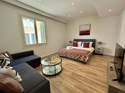a living room with a bed and a couch at Plaka Two-Bedroom Flat with Acropolis View Terrace in Athens