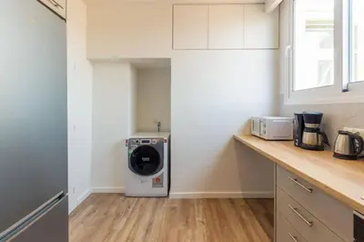 a kitchen with a washer and dryer on a counter at Plaka Two-Bedroom Flat with Acropolis View Terrace in Athens