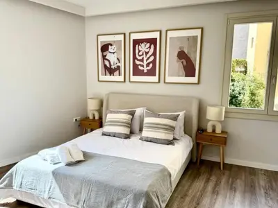 a bedroom with a bed and three pictures on the wall at Plaka Two-Bedroom Flat with Acropolis View Terrace in Athens