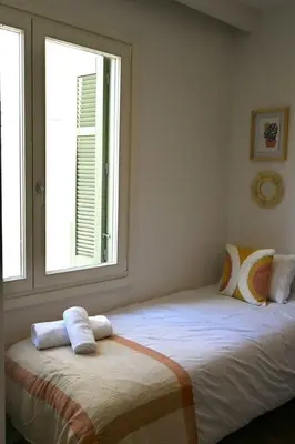 a bedroom with two beds and a window at Plaka Two-Bedroom Flat with Acropolis View Terrace in Athens
