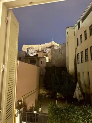 a view of a city from a balcony of a building at Plaka Two-Bedroom Flat with Acropolis View Terrace in Athens
